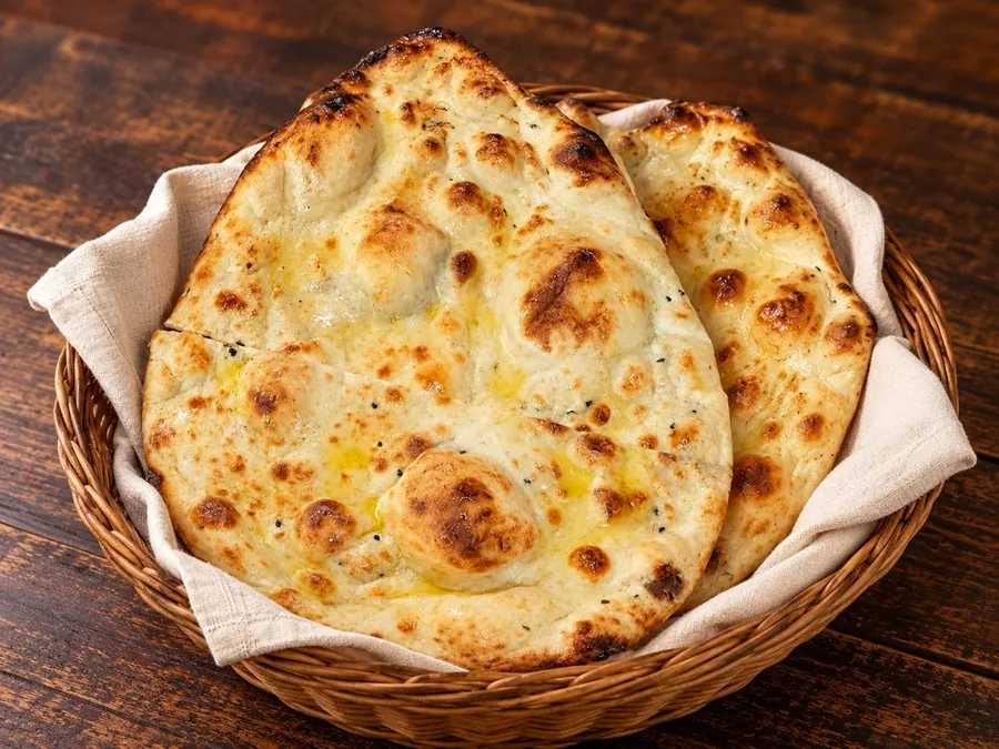 Golden butter naan made with desi ghee and milk, served in a woven basket